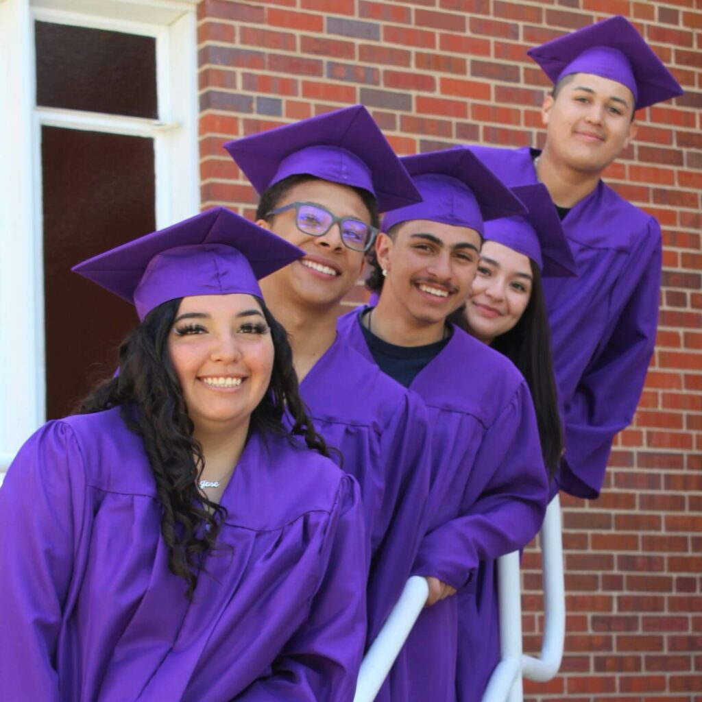 Students wearing purple graduation gown and cap - Denver Street School