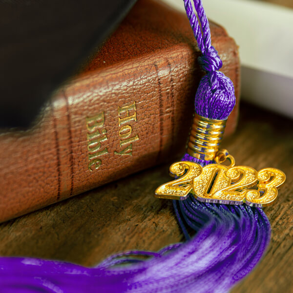 picture of a 2023 purple graduation tassel placed over a bible